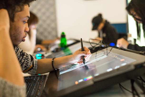 students drawing on computer screens